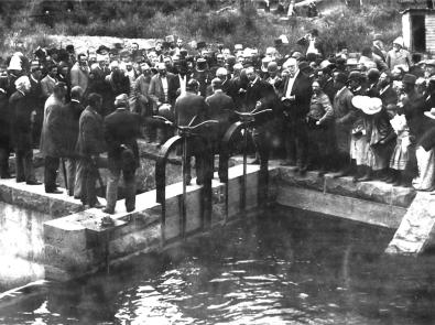 Black and white photo of men in suits at the Watts River Scheme opening
