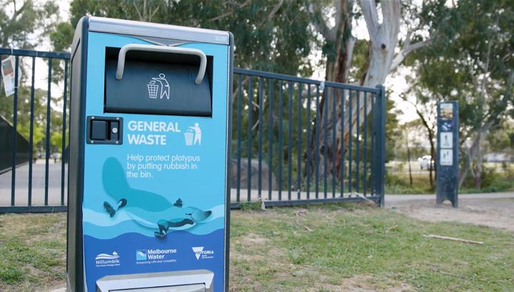 Solar-powered rubbish bin decorated with a platypus image, in a park along Diamond Creek.