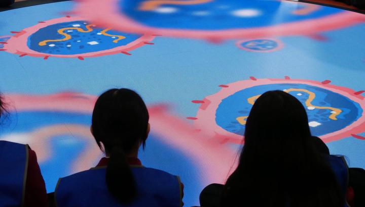 Students sit in front of circular screen at the Western Treatment Plant Education Centre