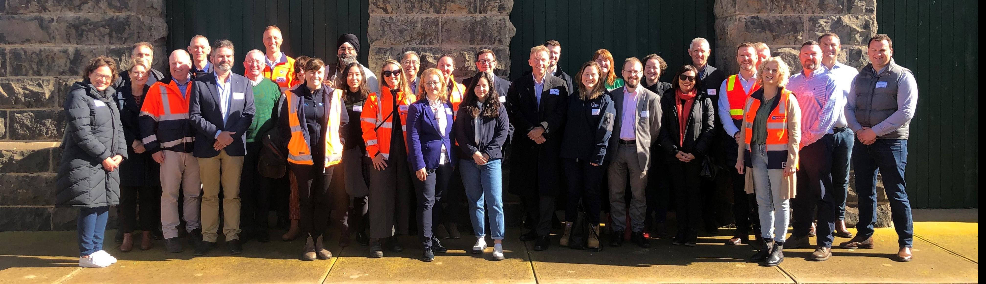 Melbourne Water staff and Victorian Government representatives, embassy officials, guests from Singapore’s National Water Authority, and a number of metropolitan water retailers and water sector peers standing together at Western Treatment Plant