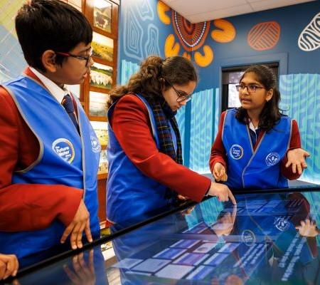 Students at touch table playing the future water story