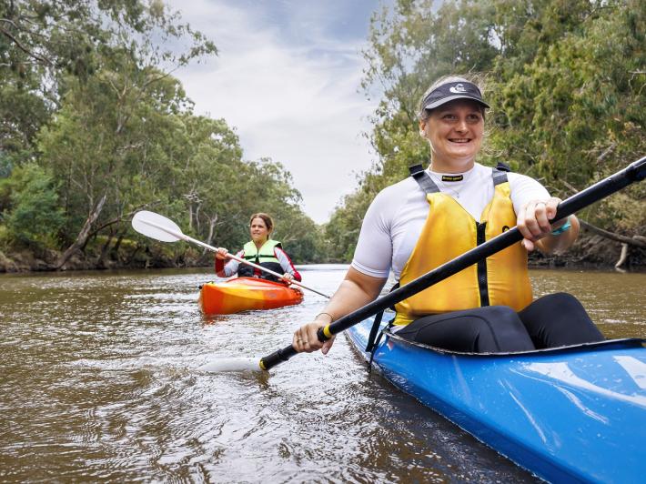 Two people kayaking in a river