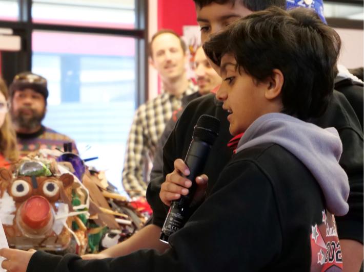 Student describes exhibit to an audience