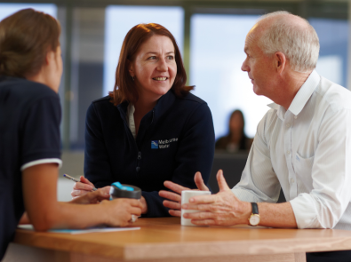 Three people in an office having a conversation