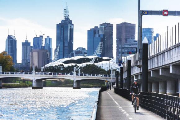 Cyclist rides along Melbourne's Yarra River